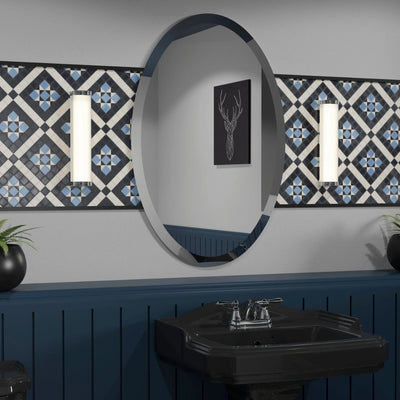 A traditionally styled mirror with an oval shape and frameless design